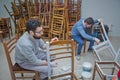 Two people. Old chairs are painted white . Azerbaijan Baku . 17.05.2020 Royalty Free Stock Photo