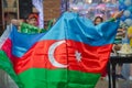 National sign background. The girl put a flag on his shoulder. Azerbaijan tradition patriotic. Flags waving wind . Azerbaijan flag