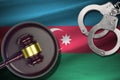 Azerbaijan flag with judge mallet and handcuffs in dark room. Concept of criminal and punishment, background for Royalty Free Stock Photo