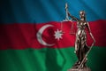 Azerbaijan flag with statue of lady justice and judicial scales in dark room. Concept of judgement and punishment Royalty Free Stock Photo