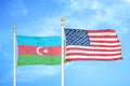 Azerbaijan and United States two flags on flagpoles and blue sky