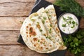 Azerbaijani food: flatbread qutab with greens and yogurt close-u