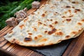 Azerbaijani Kutab with veal on a wooden board. selective focus