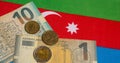 azerbaijani manat banknotes and coins with the national flag background