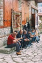 Azeri Men sitting and talking in the Street on cobblestone Huseynov street, the main street of Lahic mountainous village of Azerba