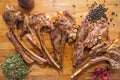 Azeri national antrikot kebab on a wooden board . Dry Satureja . Dried savory spice Satureja hortensis . Copper pepper dish .