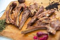 Azeri national antrikot kebab on a wooden board . Dry Satureja . Dried savory spice Satureja hortensis . Copper pepper dish .