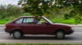 AZLK 2141 Moskvich car rides on a street. Maroon color vintage hatchback motor car rushes on the country road with blurred