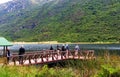 Group of senior tourists next mountain lake