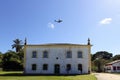 Azul airline plane flies over the museum in the historic center of Porto Seguro Royalty Free Stock Photo