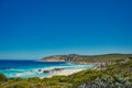Azure blue sea, rocky hills and low coastal vegetation, south coast of Western Australia. Royalty Free Stock Photo