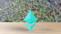 Azure Ethereum gold sign icon on wood table on leaves background. 3d render isolated illustration, cryptocurrency, crypto,