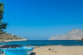 Azure fishermans boat and sea horizon line on Alexi or Alexis beach near Emborios Greek village on Kalymnos island