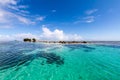 Azure turquoise blue lagoon, small uninhabited reef island motu full of dangerous rocks and mangroves trees. Pohnpei, Micronesia. Royalty Free Stock Photo