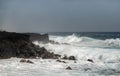 Azure wave crashes on black lava coast on Kaimu Beach, Hawaii, USA Royalty Free Stock Photo