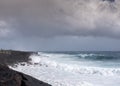 Azure wave crashes on black lava on Kaimu Beach, Hawaii, USA Royalty Free Stock Photo