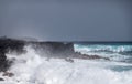 Azure waves crash on black lava coast at Kaimu Beach, Hawaii, USA Royalty Free Stock Photo