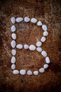 'B' alphabet made form white stone