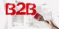 B2B abbreviation in Red and brush in hand on grunge white grey background. Business to Business Concept image