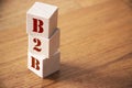 B2B business to business concept. Stack of wooden cubes on wooden floor Royalty Free Stock Photo