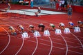 Female Sprinters Commence 100m Race from the Starting Line: Track and Field Competition Royalty Free Stock Photo