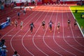 Female Sprinters Competing in 100m Race Under Stunning Sunset Light: Track and Field Event