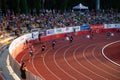 Male Sprinters Competing in 400m Race Under Captivating Sunset Light: Track and Field Event