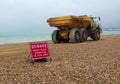 B 40D Articulated dump truck & warning sign on beach.