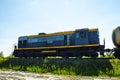 A B locomotive tows fuel tank wagon against  blue sky. Royalty Free Stock Photo