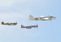 B-25 Mitchell Bomber and escorts flying on clear sky