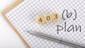 403B PLAN text concept written on the wooden cubes blocks and notebook Royalty Free Stock Photo