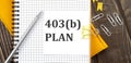 403b PLAN text on a sticker on the notebook, wooden background Royalty Free Stock Photo