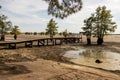 Dry lake bed with debris and fishing pier and boat ramp Royalty Free Stock Photo