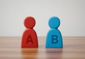 A b testing concept with red and blue wooden figures for marketing and business comparison analysis Royalty Free Stock Photo