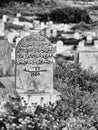 B&W closeup of tombstone engraved in Arabic in cemetery,Mahdia,Tunisia Royalty Free Stock Photo