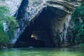 Ba Be Lakes / Vietnam, 03/11/2017: Boat passing on river through giant cave in the Northern Vietnamese Ba Be lakes region