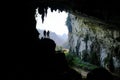 Ba Be Lakes / Vietnam, 03/11/2017: Silhouettes of two people standing in a rocky outcrop inside a giant cave in the North