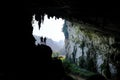 Ba Be Lakes / Vietnam, 03/11/2017: Silhouettes of two people standing in a rocky outcrop inside a giant cave in the North
