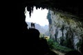 Ba Be Lakes / Vietnam, 03/11/2017: Silhouettes of two people standing in a rocky outcrop inside a giant cave in the North