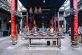 Ba Thien Hau Pagoda with stone incense burners and devoted temple worshipers in the background Royalty Free Stock Photo