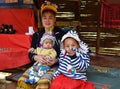 Thai long-neck Kayan woman giraffe woman with two children. Royalty Free Stock Photo