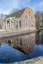 Baarn, Utrecht, The Netherlands. April 24, 2021. Orangerie of Groeneveld Castle partially reflected in the water