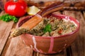 Babaganoush with tomatoes, cucumber and parsley - arabian eggplant dish or salad on wooden background. Selective focus