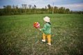 Babay girl with pinwheel at meadow Royalty Free Stock Photo