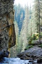 Babbling cascade water,rock walls,trees Rocky Mountains, Canada Royalty Free Stock Photo