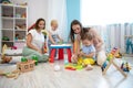 Babies with adults playing in nursery