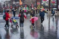 Babies and adults in the rain.