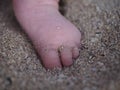 Babies feet in sand, Bali