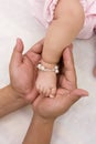 Babies foot and hand of man Royalty Free Stock Photo