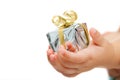 Babies hands holding small present.